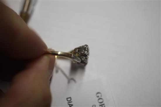 A gold and platinum, two stone diamond cross over ring, with diamond set shoulders, size O.